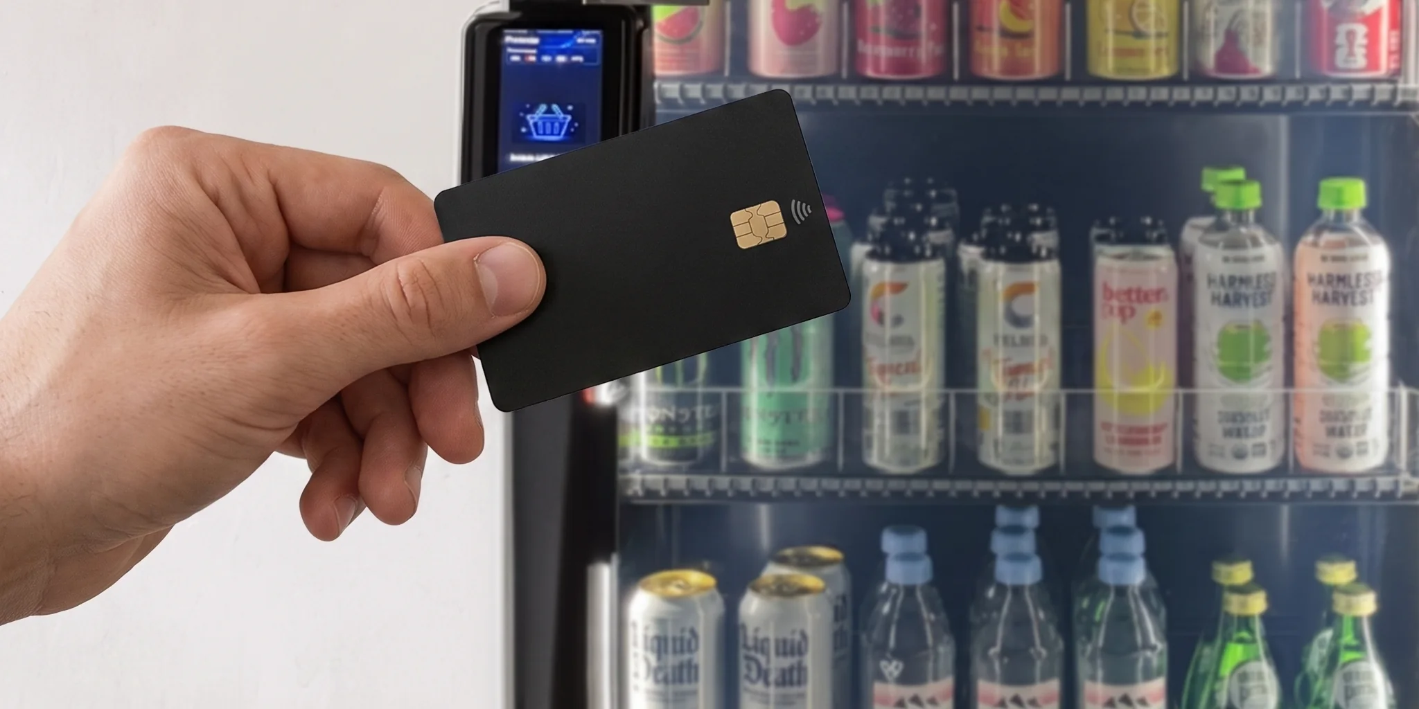 A hand holding a contactless card up to the reader on the door of a stocked cooler